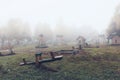 Playground in a small town in the early autumn morning. Heavy fog